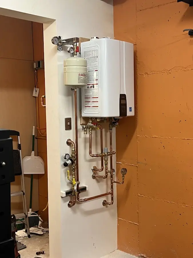 Plumbing technician inspecting water heater connections in Melbourne Beach